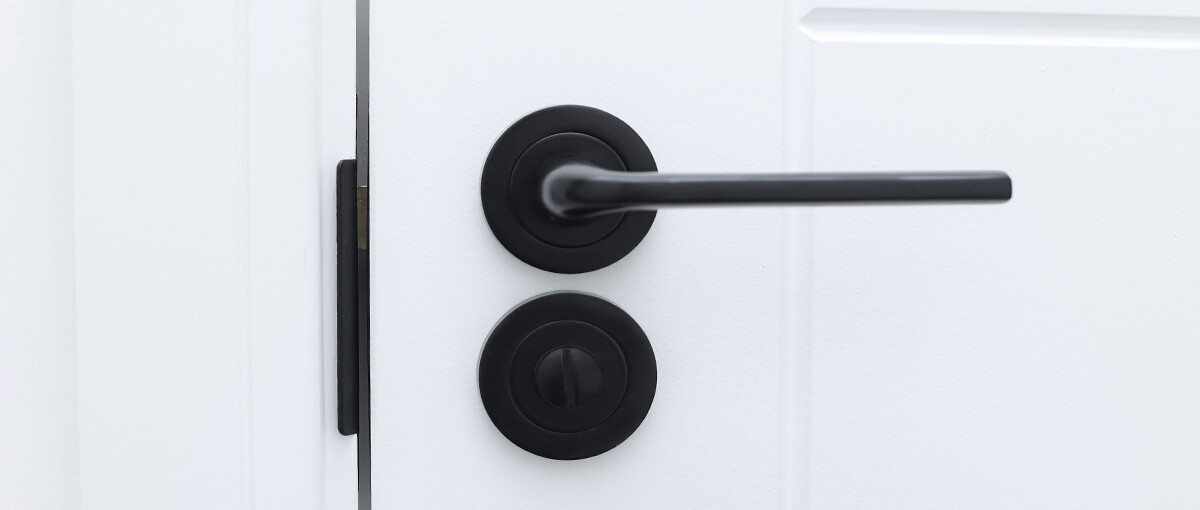 Close up of a black denleigh denura door handle and lock